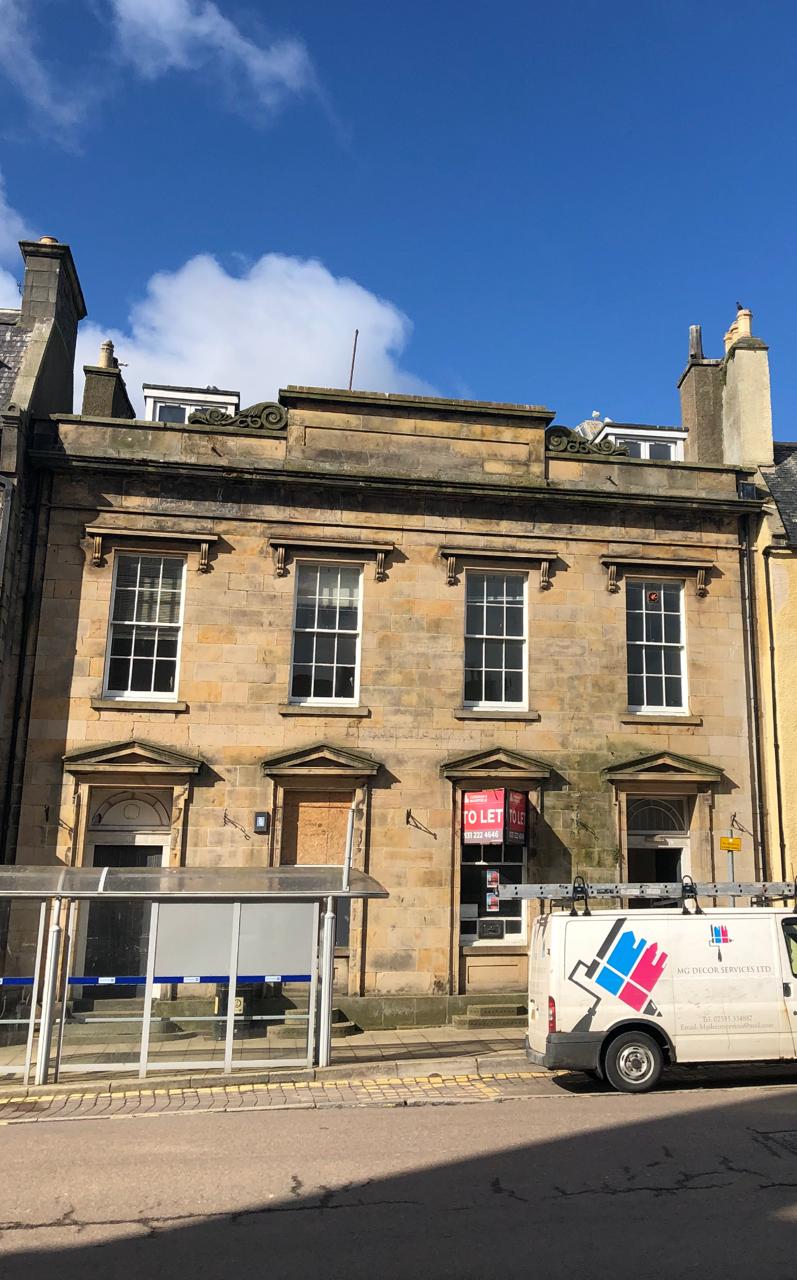 Frontal view of the former Clydesdale Bank façade in bright sunlight